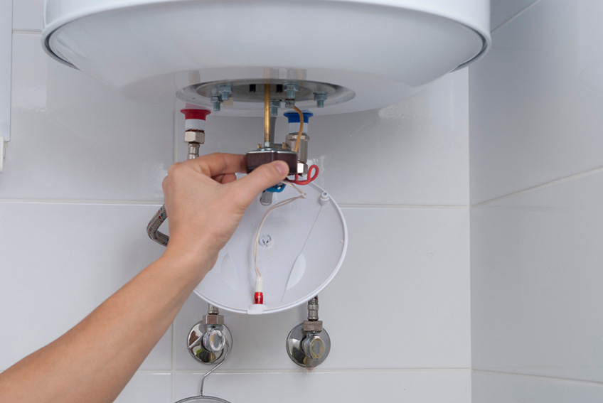 a plumber servicing the water heater