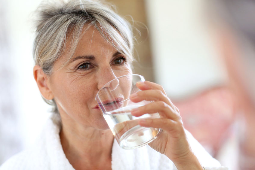a person drinking a glass of water