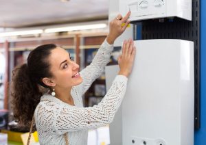 side-by-side image of traditional and tankless heater / a person shopping for water heaters