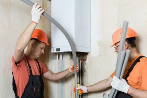 a technician putting insulation on a water heater