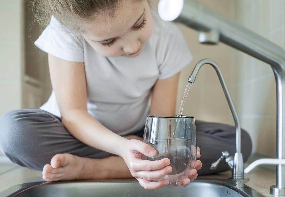 water filtration girl holding a transparent glass