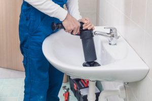 plumber performing drain cleaning Fallbrook, CA