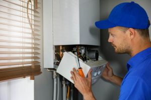 plumber inspecting a tankless water heater Temecula, CA