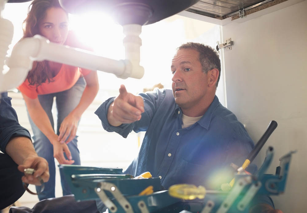 plumber talking to homeowner in Corona, CA