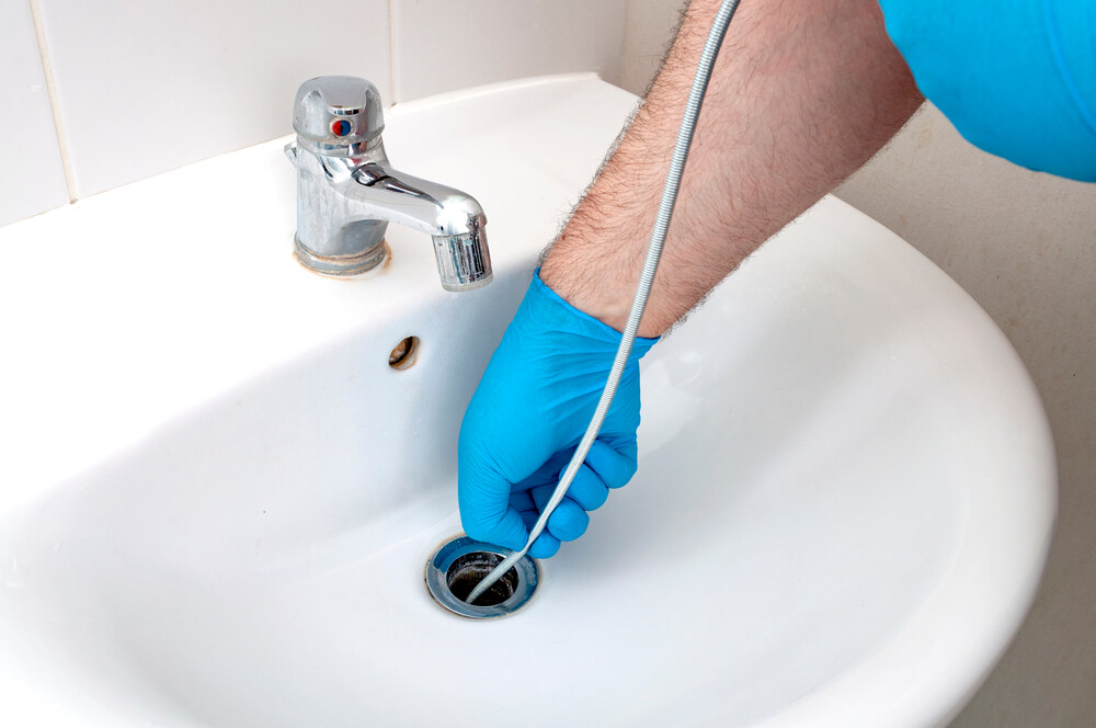 expert plumber snaking a drain