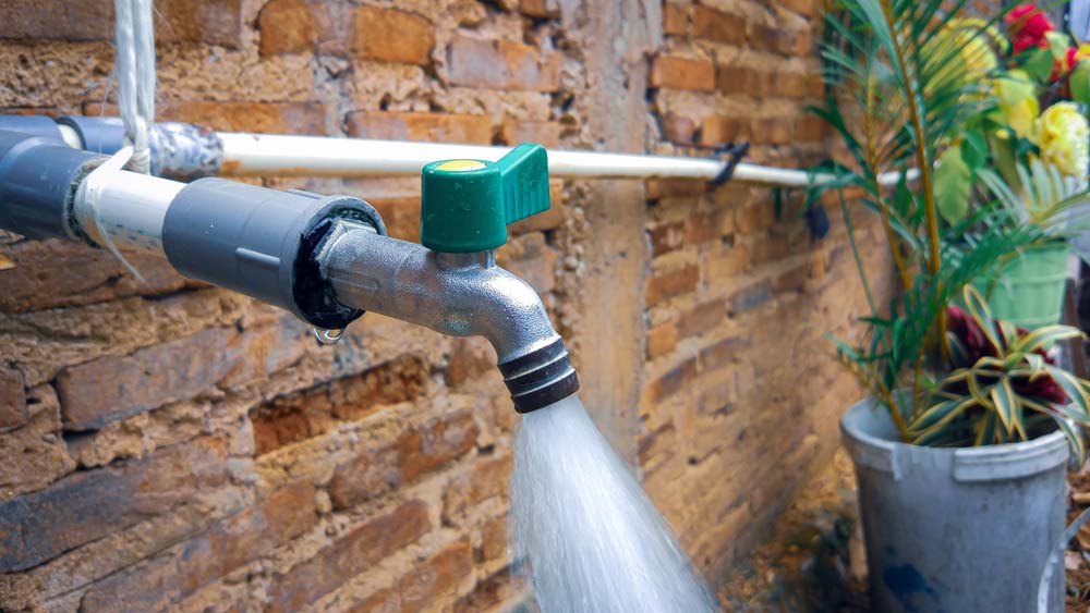 high-pressure water flowing from kitchen faucet