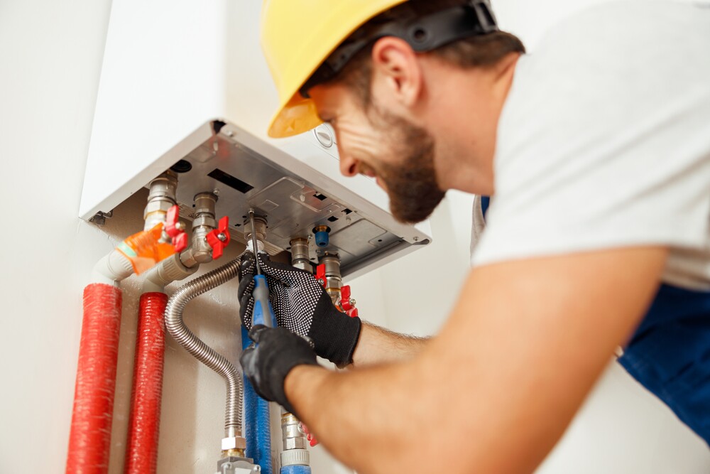 technician inspecting a water heater tank