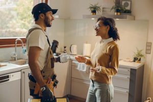 homeowner talking to a plumber