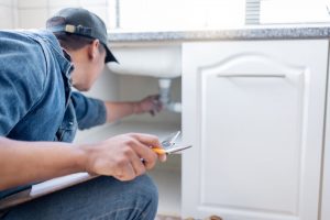 plumber inspecting pipes and drains